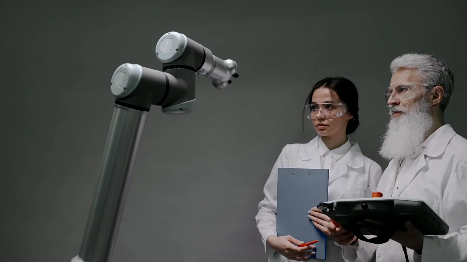 Researchers controlling a collaborative robotic arm together