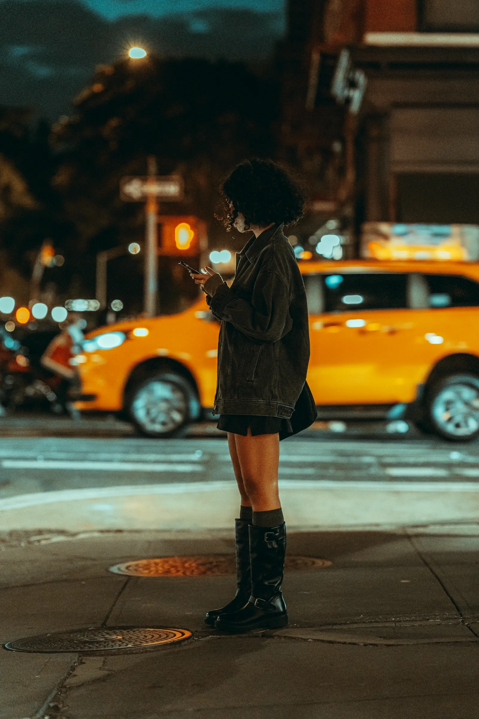 A person using a mobile phone on a vivid city street