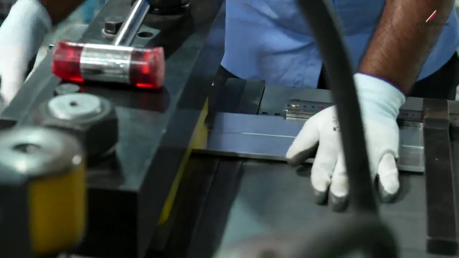 A technician assembling electrical components in the Dynalektric film