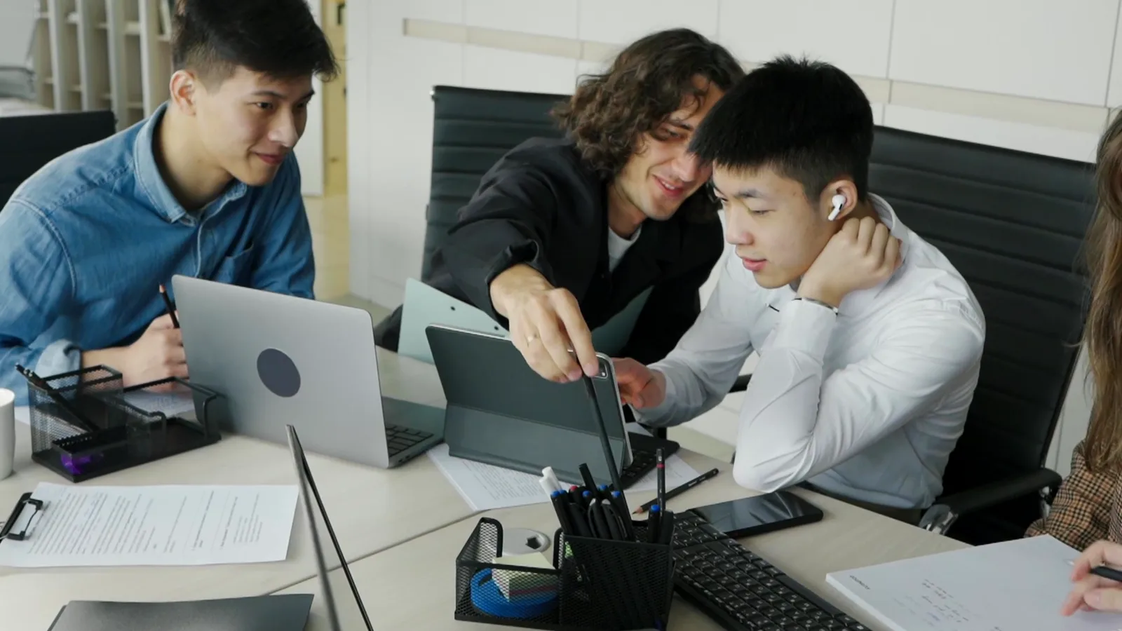 A team discussing work together on a laptop